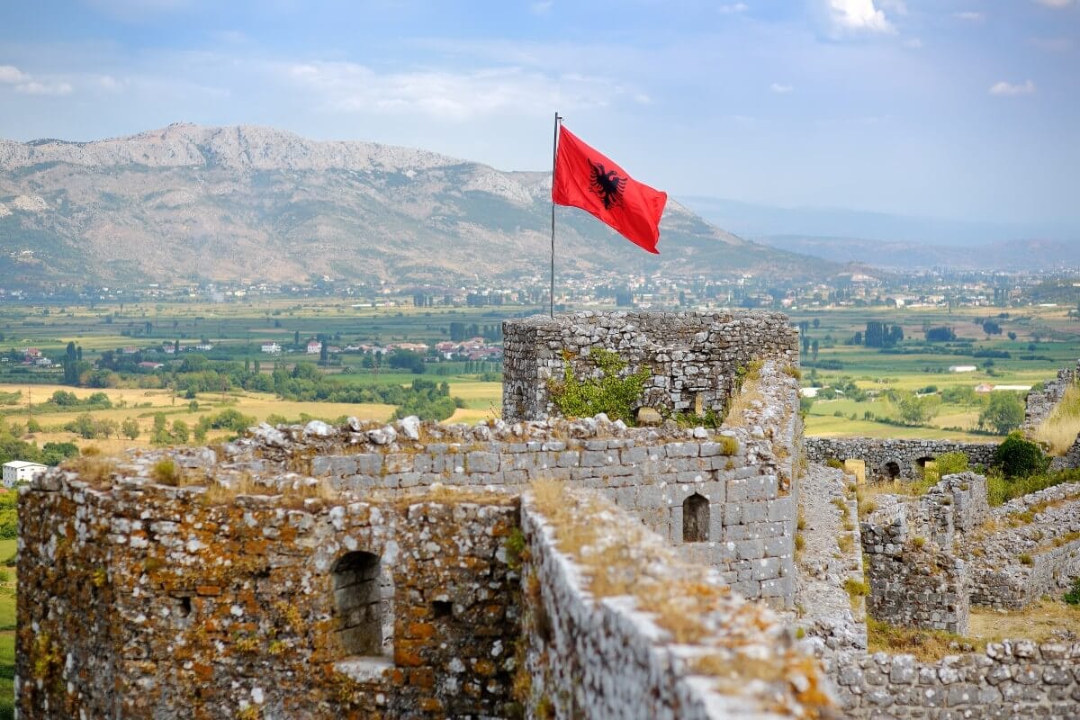 Albanian flag flying above Rozafa Castle in Shkoder, Albania